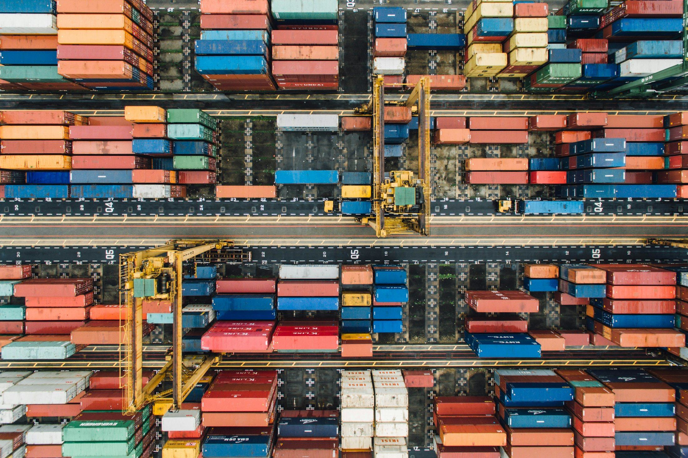 Aerial view of stacked shipping containers in an industrial port