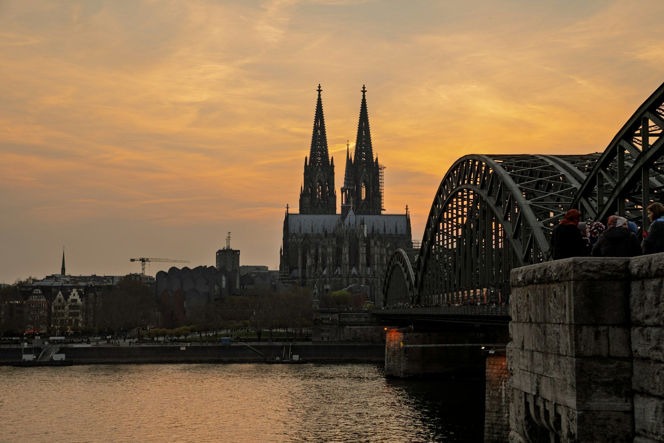 Cologne Cathedral and the Hohenzollern Bridge over the Rhine at sunset