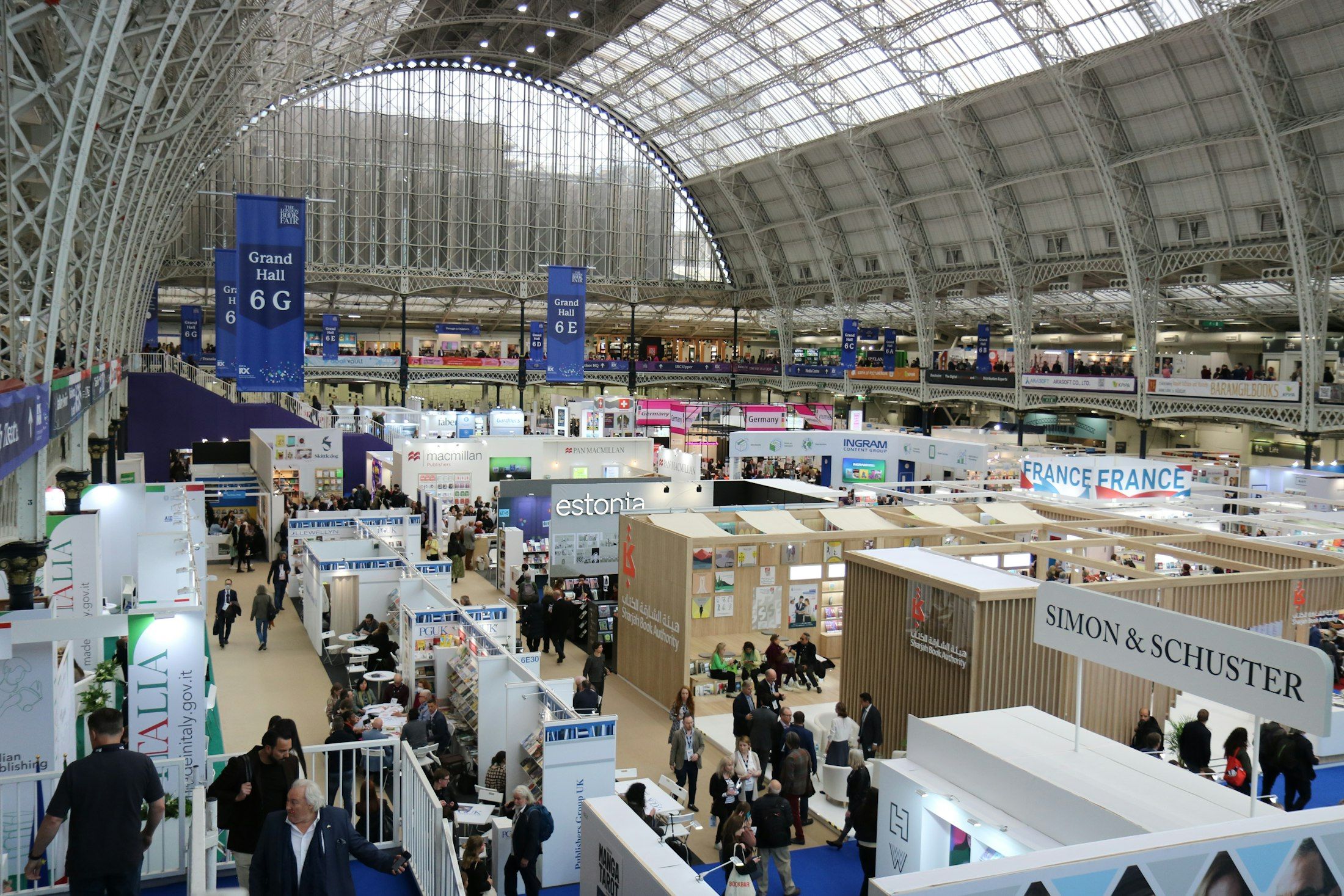 A busy trade-fair hall with exhibition stands and visitors