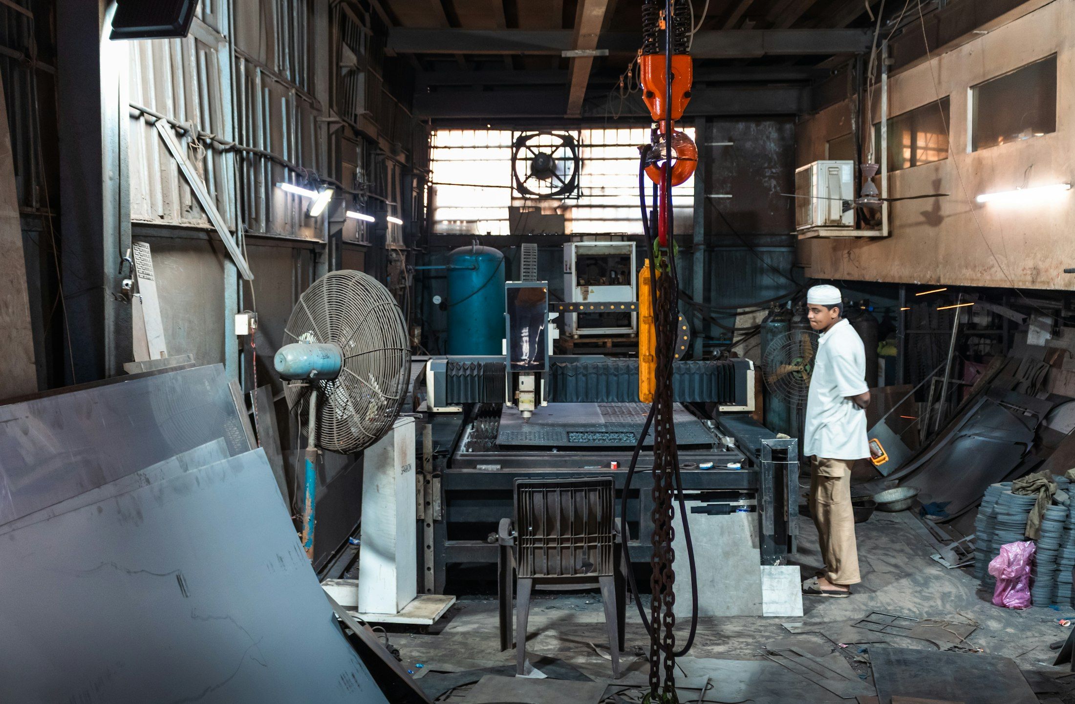 A machinist standing in an industrial workshop in India